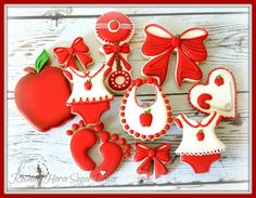 decorated cookies are arranged in the shape of an apple and baby's first year