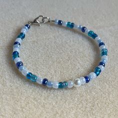 - One Of A Kind Beaded Bracelet - Featuring White, Light Blue, Dark Blue, And Translucent Blue Seed Beads, And White Pearl Center - Silver Colored Hardware - Clasps Closed. No Stretch. - Size/ Circumference Is 7.5” (See Picture) - Handmade (By Myself). Perfect To Treat Yourself Or To Give As A Gift! **Add 2 Jewelry Items Marked “2 For $20” To Your Bundle And I Will Send You An Offer For $20** Check Out The “Boutique” Tab In My Closet For Handmade Earrings, Bracelets, And Necklaces! Beads Bracelet Design Blue, Bracelet Inspo Seed Beads, Blue Seed Bead Bracelet, Bracelet Ideas Seed Beads, Beaded Bracelets Blue, Cute Beaded Bracelets, Light Blue Bracelet, Ombre Bracelet, Jewelry Stacking