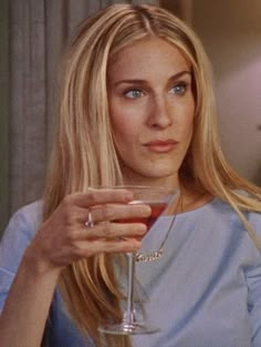 a woman holding a martini glass in her hand