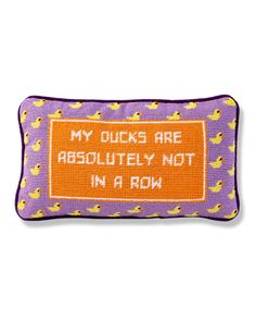 a purple and orange pillow that says, my ducks are absolutely not in a row