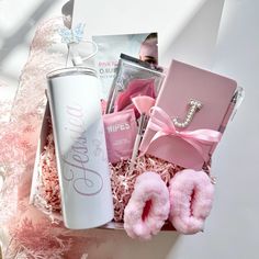 a pink gift box filled with personal care items, including an inflatable bottle and slippers