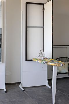 an ironing board sitting on top of a white table