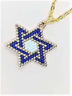 a blue and white beaded star on a gold chain