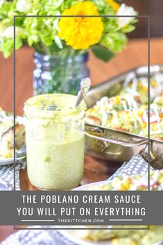 a table topped with food and a glass jar filled with cream sauce on top of it