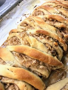 bread with meat and cheese on it sitting in a pan