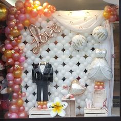 a display with balloons and decorations for a wedding