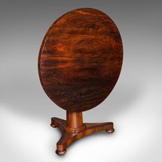 an oval wooden table with four legs