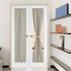 a white door with curtains on it in front of a book shelf and bookshelf