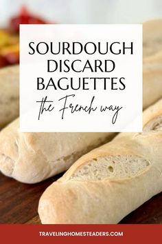 two loaves of bread sitting on top of a wooden cutting board with the words sourdough disgard baguettes