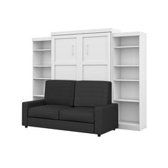 a black and white couch sitting next to a book shelf with doors on each side