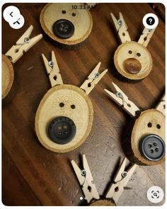 several wooden buttons with holes in them sitting on top of a wood floor next to each other