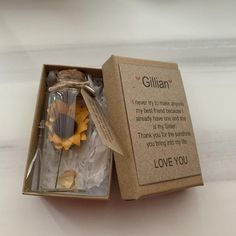 an open gift box with a message inside it and flowers in the bottom right hand corner