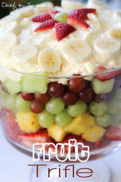 a fruit salad with bananas, grapes and strawberries