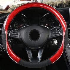 the steering wheel cover is red and black with white stitching on it's sides