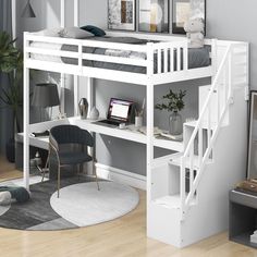 a white loft bed with stairs and desk in the corner, next to a chair