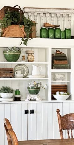 a wooden table sitting in front of a white book shelf