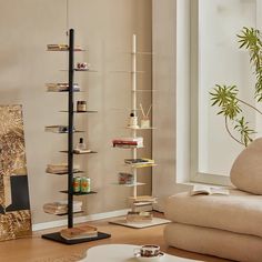 a living room filled with furniture and a tall book shelf