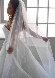 a woman wearing a wedding dress and veil