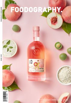 a bottle of pink liquid surrounded by peaches and other fruit on a pink background