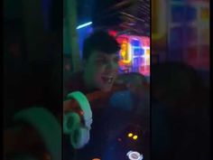 three different shots of a young man dancing at a party in the dark with neon lights behind him