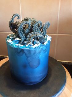 there is a blue cake with an octopus on it