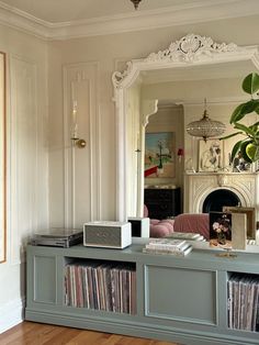 a living room filled with furniture and a large mirror