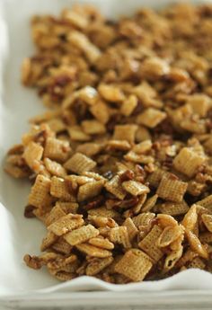 a white plate topped with cereal and nuts