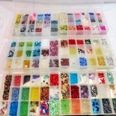 many different colors of beads in a plastic container