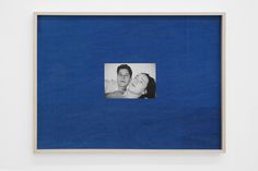 a blue frame with a black and white photo of a man and woman in it