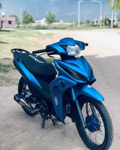 a blue motorcycle parked on the side of a road