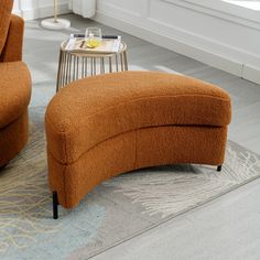 an orange chair and ottoman in a living room