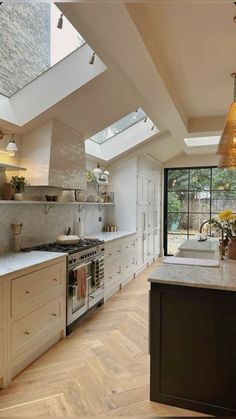 an open kitchen with skylights and white cabinets