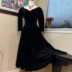 Vintage Velvet 1980's Sexy Elizabethan Gothic Glamour Gown Fit For Royalty! 3/4 Length Sleeves. Deep V-Neckline In Front. Deep U-Neckline In Back. V-Shaped Waistline Echos The V-Shaped Neckline As It Is Shaped To A Deep V In The Center Front Of Waist. Waistline Seam Is Expertly Piped In Heavy Narrow Satin Where Bodice Is Joined To Skirt. The Same Narrow Piping Finishes The Neckline Edges And The Sleeve Cuffs. Dress Is Very Well Made. Bodice Is Princess Seamed Thus Fitted And Sculpted To The Torso. Fastens With Covered Velvet Buttons Up The Back. Sleeves Are Puffed. The Fabric Is A High Quality Weighty Velvet. Made In Great Britain In The Early 1980’s. This Reminds Me Of The Gowns Worn By Black Long Sleeve Vintage Dress For Formal Occasions, Black Vintage Evening Dress For Fall, Retro Long Sleeve Evening Vintage Dress, Retro Long Sleeve Vintage Evening Dress, Elegant Vintage Evening Dress For Winter, Retro Full Length Evening Dress, Fitted Vintage Dress For Formal Winter Event, Fitted Vintage Dress For Winter Formal, Formal Fitted Vintage Dress For Winter