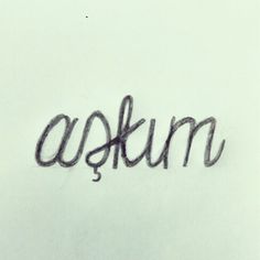 the word askum written in black ink on a white paper with an eraser pen