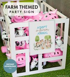 a farm themed party sign with pink and black cows in a white crate on grass