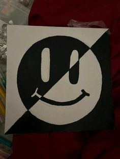 a black and white sign with a smiley face