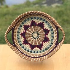 a woven basket sitting on top of a wooden table