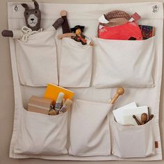 the hanging organizer is organized with several pockets for toys, books and other personal items