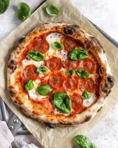 a pizza sitting on top of a piece of wax paper