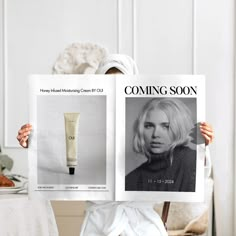 a woman holding up a magazine with an image of a blonded woman on it