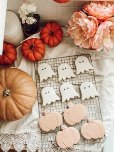 decorated cookies and pumpkins on a table