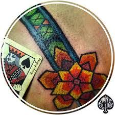 an image of a tattoo on the back of a person's stomach with a playing card in front of it