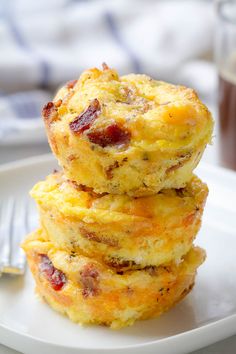 three breakfast muffins stacked on top of each other with a fork next to them