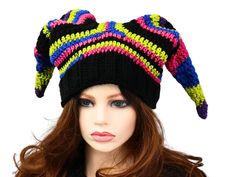 Have some winter fun and stand out with this Whimsical Court Fool Hat. I've crocheted this in neon goth colors, with a knitted ribbed band for easy stretch and fit. The stripes are blended with black for that extra pop. It gives a touch of fae, or impish sprite vibes and is just pure fun. Certain to add a unique character when you are out and about, skiing, snowboarding, going to an outdoor concert, a festival, hiking through the forest, or even a fun costume accessory! Makes a fun gift for him or her. Lots of stretch, so one size will fit most. Machine wash cold and toss it in the dryer. Fun Fitted Hat For Festival, Handmade Fitted Multicolor Hats, Whimsical Multicolor Cap, Fitted Costume Hats And Headpieces For Winter Festival, Whimsical Multicolor Beanie Hat, Funky Winter Festival Hats, Fun Winter Festival Hats, Fitted Multicolor Winter Hats, Bohemian Multicolor Mini Hats For Winter