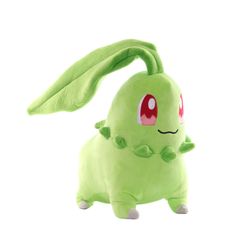 a green stuffed animal with red eyes on it's head and tail, standing in front of a white background