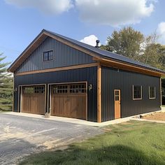 a two car garage is shown in the middle of a grassy area with trees around it