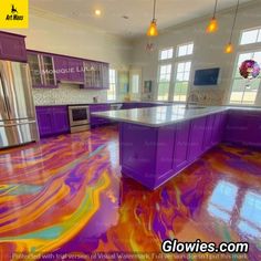 a kitchen with purple and orange marble flooring in the middle of it, surrounded by stainless steel appliances