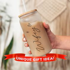 a woman holding a drink with the words unique gift idea