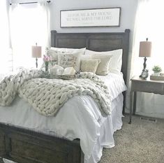 a bed with white blankets and pillows in a bedroom