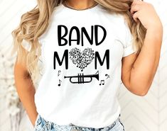 Cute Gift For A Trumpet Band Mom. Fun Shirt To Wear To Band Concert to support your son or daughter that is in the band. Cute Marching Band Mom Gift that she can wear all year long.  Shop More Band Gifts: https://www.etsy.com/shop/MommyMakesGifts?ref=seller-platform-mcnav&search_query=band Gildan unisex and Bella Canvas unisex shirts are used depending on the color of shirt picked.  Please specify if you prefer one over the other.    Trumpet Can Be Changed To A Different Instrument If Needed. This product is made especially for you as soon as you place an order, which is why it takes us a bit longer to deliver it to you. Making products on demand instead of in bulk helps reduce overproduction, so thank you for making thoughtful purchasing decisions! * 100% ring-spun cotton * Sport Grey is Band Mom Shirts Ideas, Trumpet Shirts, Marching Band Gift, Marching Band Mom, Band Gifts, Band Mom Shirts, Cute Music, Band Mom, Band Concert